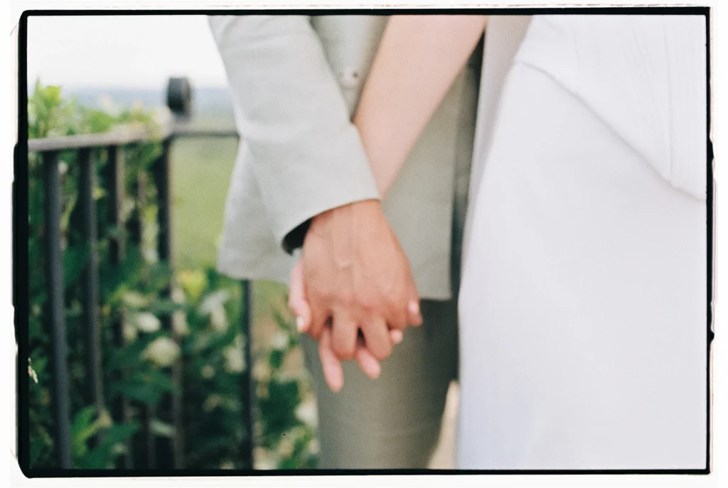 Close up of couple holding hands on 35mm analog film with borders. Mallorca wedding photography by Jessica North.